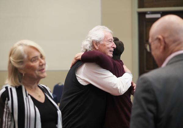 Richard Hayes hugging an attendee
